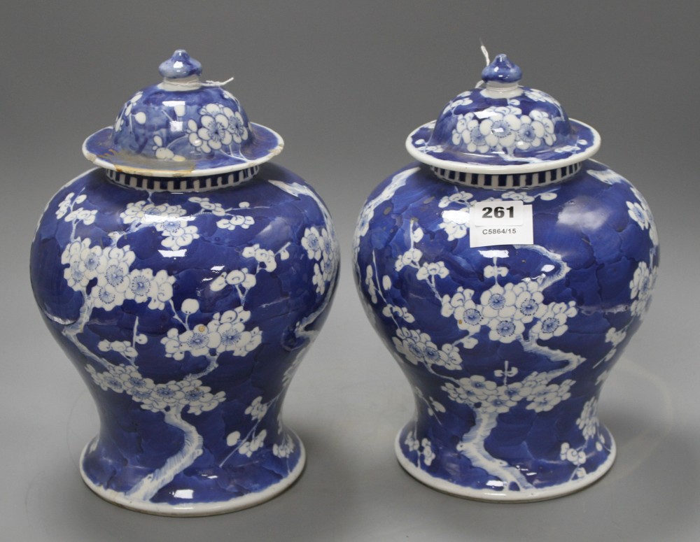 A pair of late 19th century Chinese prunus pattern baluster vases and covers, height 29cm